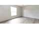 Bright bedroom with wood-look flooring and large window at 520 Branch Bend Way, Cross, SC 29436