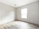 Bright bedroom with wood-look flooring and large window at 520 Branch Bend Way, Cross, SC 29436