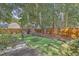Landscaped backyard with putting green and trees at 602 Leaning Pin Ct, Summerville, SC 29485
