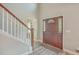 Bright entryway with hardwood floors, a wooden staircase, and a dark wood door at 602 Leaning Pin Ct, Summerville, SC 29485