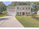 Two-story house with a neutral exterior, landscaped lawn, and driveway at 602 Leaning Pin Ct, Summerville, SC 29485