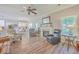 Open living room with hardwood floors, fireplace, and kitchen view at 602 Leaning Pin Ct, Summerville, SC 29485