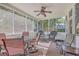 Relaxing screened porch with patio furniture and ceiling fan at 602 Leaning Pin Ct, Summerville, SC 29485
