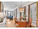 Bright dining area with a round table and four orange chairs, hardwood floors, and large windows at 656 Coleman Blvd # 606, Mount Pleasant, SC 29464