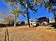 Large backyard with mature trees and a partially visible home at 8731 Evangeline Dr, North Charleston, SC 29420