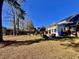 Large backyard with mature trees and a partially visible home at 8731 Evangeline Dr, North Charleston, SC 29420