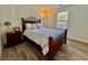 Charming bedroom featuring wood floors and a wood frame bed at 8731 Evangeline Dr, North Charleston, SC 29420