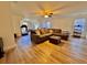 Large bonus room with L-shaped sofa and hardwood floors at 8731 Evangeline Dr, North Charleston, SC 29420