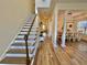 Bright entryway with hardwood floors, staircase, and view of dining room at 8731 Evangeline Dr, North Charleston, SC 29420