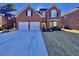 Brick two-story house with a two-car garage and a basketball goal at 8731 Evangeline Dr, North Charleston, SC 29420
