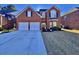 Brick two-story house with a two-car garage and a basketball goal at 8731 Evangeline Dr, North Charleston, SC 29420