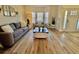 Living room with hardwood floors, comfy sofas, and bay window at 8731 Evangeline Dr, North Charleston, SC 29420