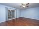 Bedroom with hardwood floors, ceiling fan, and sliding glass door at 8875 Jenny Lind St, North Charleston, SC 29406