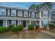 Tan two story townhome with black shutters, and landscaping at 8875 Jenny Lind St, North Charleston, SC 29406