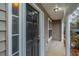 Black front door with sidelights, leading to a covered porch at 8875 Jenny Lind St, North Charleston, SC 29406