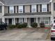 Two-story tan house with black shutters and multiple entrances at 8875 Jenny Lind St, North Charleston, SC 29406