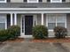 Tan house with white columns, black door, and landscaping at 8875 Jenny Lind St, North Charleston, SC 29406