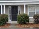 Tan house with white columns, black door, and landscaping at 8875 Jenny Lind St, North Charleston, SC 29406