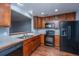 Modern kitchen with black appliances and wood cabinets at 8875 Jenny Lind St, North Charleston, SC 29406