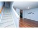 Carpeted stairway leading to upper level, hardwood floors at 8875 Jenny Lind St, North Charleston, SC 29406