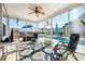 Screened porch overlooking pool, with seating and ceiling fan at 9930 Winged Elm St, Ladson, SC 29456