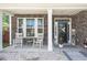 Charming front porch with rocking chairs and stone facade at 103 Oyama Rd, Summerville, SC 29486