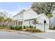 White house with red metal roof, two-car garage, and manicured lawn at 1086 Cinder St, Mount Pleasant, SC 29464