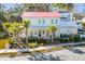 Two-story white house with red metal roof, landscaping, and palm trees at 1086 Cinder St, Mount Pleasant, SC 29464