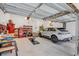 Spacious garage with overhead storage, a car, and various tools and equipment at 1086 Cinder St, Mount Pleasant, SC 29464