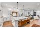 Bright white kitchen with island, stainless steel appliances, and hardwood floors at 1086 Cinder St, Mount Pleasant, SC 29464