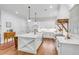 White kitchen with large island and wood range hood at 1086 Cinder St, Mount Pleasant, SC 29464