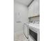 Clean laundry room with white cabinets, washer, dryer, and patterned tile floor at 1086 Cinder St, Mount Pleasant, SC 29464