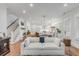 Open living room and kitchen with white sofa and hardwood floors at 1086 Cinder St, Mount Pleasant, SC 29464