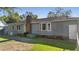 Home's rear elevation, showcasing a patio, hot tub, and grassy yard at 115 Three Wood Ln, Summerville, SC 29483