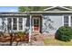 Red front door with a glass insert and brick steps at 115 Three Wood Ln, Summerville, SC 29483
