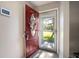 Front entry with a red door and storm door at 115 Three Wood Ln, Summerville, SC 29483