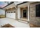 Brick front exterior with a black front door and two-car garage at 117 Arabian Drive Lot B, Summerville, SC 29483