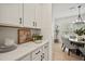 Kitchen features white cabinets, quartz countertops, and view of dining area at 117 Arabian Drive Lot B, Summerville, SC 29483