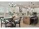 Bright kitchen with island, white cabinets, and dining area at 117 Arabian Drive Lot B, Summerville, SC 29483