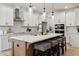 Modern kitchen with white cabinets, large island and pendant lighting at 117 Arabian Drive Lot B, Summerville, SC 29483