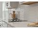 Modern kitchen with white cabinets, quartz countertops, and glass cooktop at 117 Arabian Drive Lot B, Summerville, SC 29483