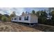 Single-wide manufactured home on a sloped lot with dark shutters at 1225 Old Black Oak Rd, Moncks Corner, SC 29461