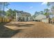 Spacious backyard with a large grassy area and shed at 123 Beam St, Huger, SC 29450