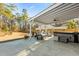 Covered patio with hot tub, seating area, and a large backyard at 123 Beam St, Huger, SC 29450