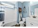 Bathroom with white vanity, tub, and blue walls at 123 Beam St, Huger, SC 29450