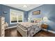 Bedroom with large window, double dresser, and hardwood floors at 123 Beam St, Huger, SC 29450