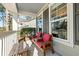 Front porch with red cushioned chairs and a wooden bench at 123 Beam St, Huger, SC 29450