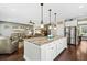 Open concept kitchen with island, stainless steel appliances, and white cabinets at 123 Beam St, Huger, SC 29450