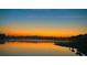 Sunrise over a tranquil lake with reflection and homes at 123 Beam St, Huger, SC 29450