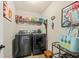 Bright laundry room with washer, dryer, and shelving at 123 Beam St, Huger, SC 29450